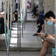 People ride on a mass rapid transit train in Singapore on November 5, 2021.